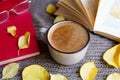 Autumn flatlay with cup of coffee, books, glasses, yellow leaves and books on scarf background Royalty Free Stock Photo