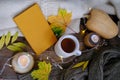 autumn flatlay in style Scandinavian hugg with tea in mugwarm woolen clothes, yellow leaves, book on wooden table