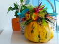 Autumn floral bouquet in a pumpkin vase. Bright autumn composition for Halloween