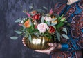 Autumn floral bouquet in pupkin vase. Floral decoration in woman Royalty Free Stock Photo