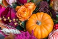 Autumn flowers floral background. Bouquet with pumpkin close up, macro