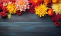 Autumn flowers frame on wooden background. Seasonal yellow and red flowers. Autumn background. Space for text Royalty Free Stock Photo