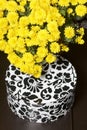 Autumn flowers in a pot. Yellow Chrysanthemum. Next gift in a cardboard box with an ornament. On a gray background. Royalty Free Stock Photo