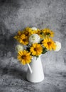 Autumn flowers yellow and white dahlias bouquet in a vintage white metal jug on a gray background, front view Royalty Free Stock Photo