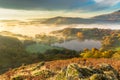 Autumn Fog Lingering Over Loughrigg Tarn In The English Lake District.