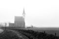 Autumn foggy morning, church of Den Hoorn on Texel island in the Netherlands Royalty Free Stock Photo