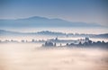 Autumn foggy morning in mountains. Alpine village on the hills Royalty Free Stock Photo