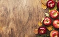 Autumn food background. Ripe apples with nuts, fallen leaves and cinnamon on rustic wooden table. Top view. Copy space Royalty Free Stock Photo