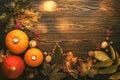 Autumn food top view, Thanksgiving or Halloween background: pumpkins, nuts, fallen leaves and spices on brown wooden background.