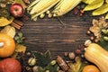 Autumn food top view, Thanksgiving or Halloween background: pumpkins, nuts, fallen leaves and spices on brown wooden background. Royalty Free Stock Photo