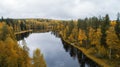 Autumn forest and cloudy sky reflected in the water. Yellow autumn trees near the water. Yellow Birch reflected in clean lake in t Royalty Free Stock Photo