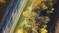 Autumn forest drone aerial shot, Overhead view of foliage trees and road Royalty Free Stock Photo