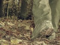 Woman in high leather shoes or boots walking on fallen leaves Royalty Free Stock Photo