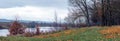 Autumn forest with fallen leaves near the river, panorama Royalty Free Stock Photo