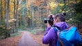 Autumn in the forest. A girl is photographing a beautiful forest. Royalty Free Stock Photo