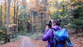 Autumn in the forest. A girl is photographing a beautiful forest. Royalty Free Stock Photo