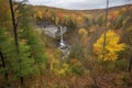 autumn forest hike with view of cascading waterfall Royalty Free Stock Photo