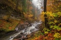 autumn forest hike, with view of majestic waterfall and rushing stream Royalty Free Stock Photo