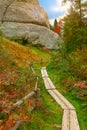 Autumn forest in the mountains and stairs in rock