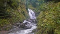 Autumn in the forest. The waterfall flows into the rocky bed of the mountain river. Royalty Free Stock Photo