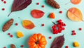 Autumn frame with leaves, rowan berries, orange pumpkins, pine cones on pastel background, flat lay. Fall, thanksgiving concept. Royalty Free Stock Photo