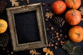 Autumn frame made of pumpkins, tree leaves, hazelnuts on black background. Autumn, fall, thanksgiving concept. Flat lay, copy