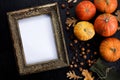 Autumn frame made of pumpkins, tree leaves, hazelnuts on black background. Autumn, fall, thanksgiving concept. Flat lay, copy