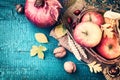 Autumn frame with pomegranate, apple and fall leaves. Fall background