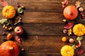 Autumn frame top border of colorful pumpkins, acorns, fall leaves, berries on wooden desk table. Flat lay, top view, copy space. Royalty Free Stock Photo