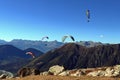 Paragliders soaring the deep blue sky.