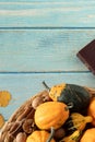 Autumn fruit, nuts, leaves, and closed holy bible on wooden table