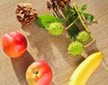 Autumn fruits, cone, chestnuts, apple, nectarine, banana and lea