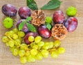 Autumn fruits, cone, chestnuts, plum, grapes and leaves on wood Royalty Free Stock Photo