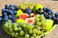 Autumn fruits on a plate. Figs and grapes Royalty Free Stock Photo