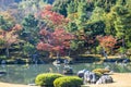 An autumn garden at the Tenryu-Ji Temple in Kyoto Japan with the colors of fall reflecting in the calm water Royalty Free Stock Photo