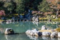 An autumn garden at the Tenryu-Ji Temple in Kyoto Japan with the colors of fall reflecting in the calm water Royalty Free Stock Photo