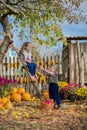 Autumn gathering apples on the farm. Children collect fruit in the basket. Outdoor fun for kids.