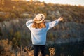 Autumn girl in blue sweater and hat standing backwards and admire nature lake view. Autumn forest colors with girl back Royalty Free Stock Photo