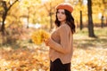 Autumn girl in city park. Fall female portrait of happy lovely and beautiful Caucasian young woman in forest in fall Royalty Free Stock Photo