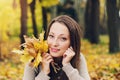 Autumn girl playing in city park. Fall woman portrait of happy lovely and beautiful young woman in forest in fall colors. Royalty Free Stock Photo