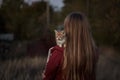 Autumn girl with red kitten