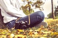 Autumn, girl sitting in a park with camera