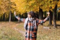 Autumn girl walking in city park. Portrait of happy lovely and beautiful young woman in forest in fall colors. Royalty Free Stock Photo