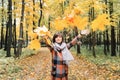Autumn girl walking in city park. Portrait of happy lovely and beautiful young woman in forest in fall colors. Royalty Free Stock Photo