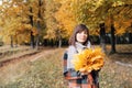 Autumn girl walking in city park. Portrait of happy lovely and beautiful young woman in forest in fall colors. Royalty Free Stock Photo