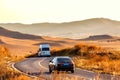 Autumn grassland, country road, car driving Royalty Free Stock Photo