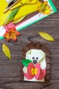 Autumn Greeting postcard hedgehog with an apple on a wooden table. Handmade. Project of children`s creativity, handicrafts, craft Royalty Free Stock Photo