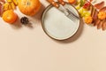 Autumn Halloween or Thanksgiving day table setting. Autumn background with an empty plate, cutlery, pumpkins. Thanksgiving Royalty Free Stock Photo