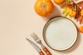 Autumn Halloween or Thanksgiving day table setting. Autumn background with an empty plate, cutlery, pumpkins. Thanksgiving Royalty Free Stock Photo