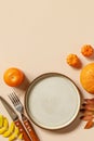 Autumn Halloween or Thanksgiving day table setting. Autumn background with an empty plate, cutlery, pumpkins. Thanksgiving Royalty Free Stock Photo